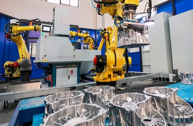 Robotic handling equipment beside metal housing forms