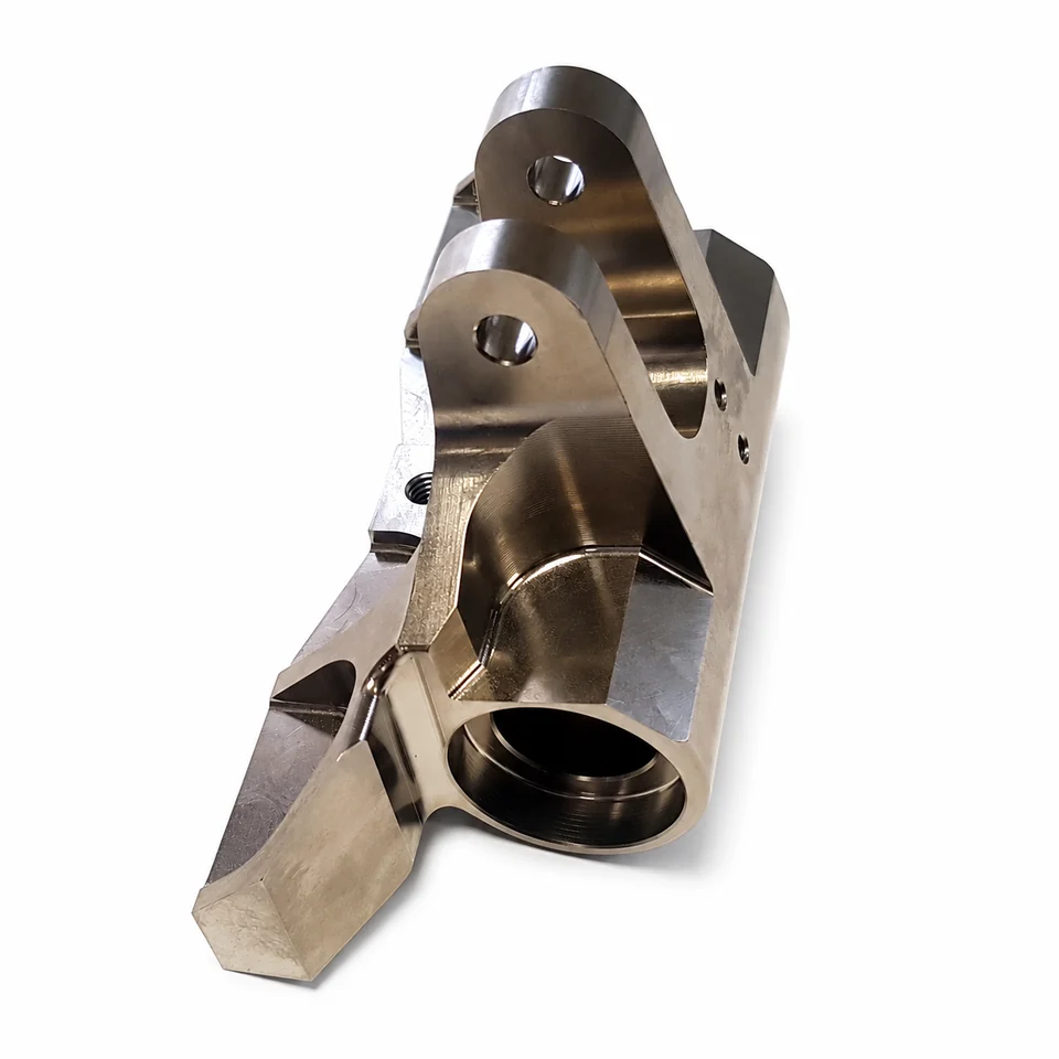 Machined component with bores, steps and attachment interfaces