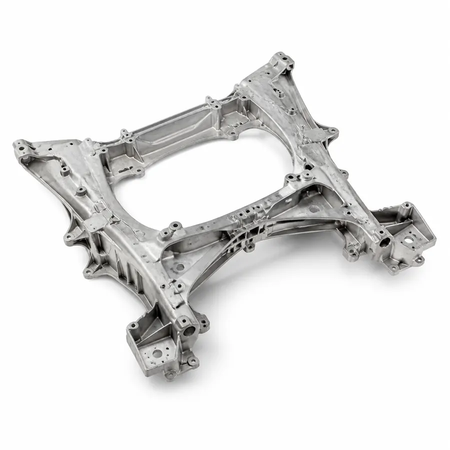 Large one-piece aluminum rear underbody casting on white background